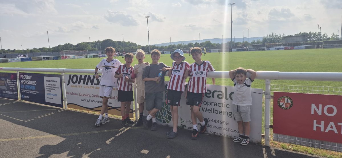 Cheetahs players pitchside watching Cheltenham Town play Evesham in pre-season