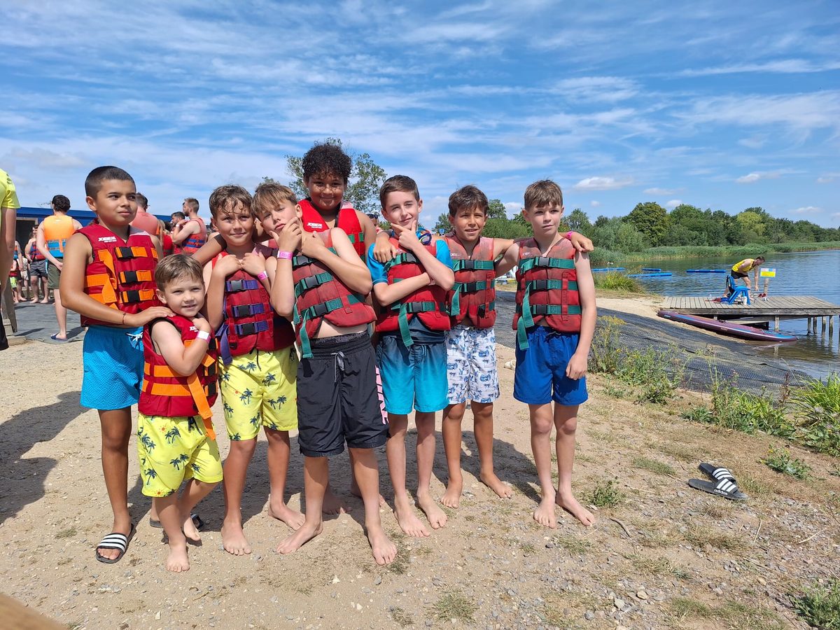 Cheetahs players in life jackets on the beach at Cotswold Country Park