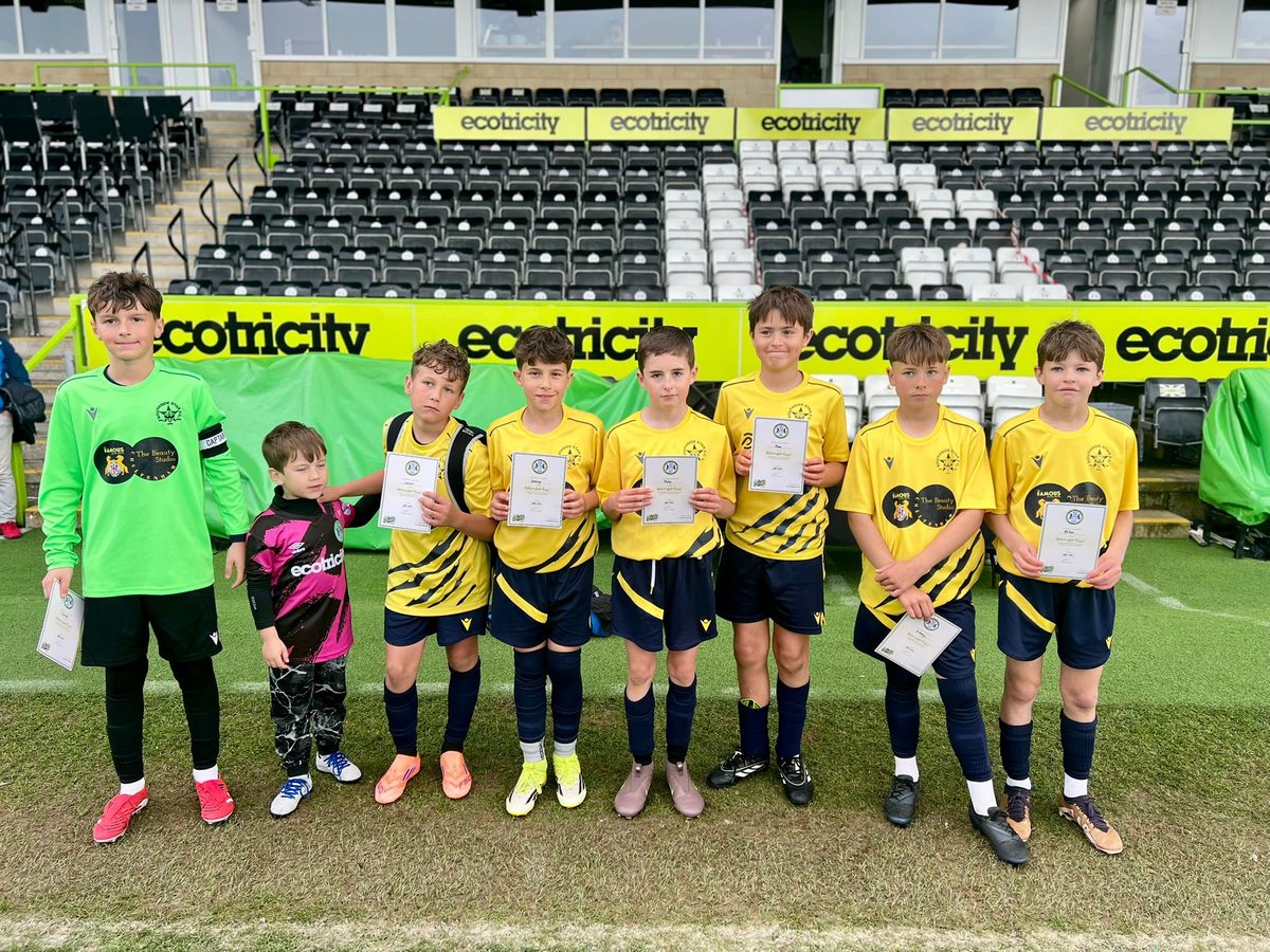 The Cheetahs with their certificates in the stand at Forest Green Rovers Stadium