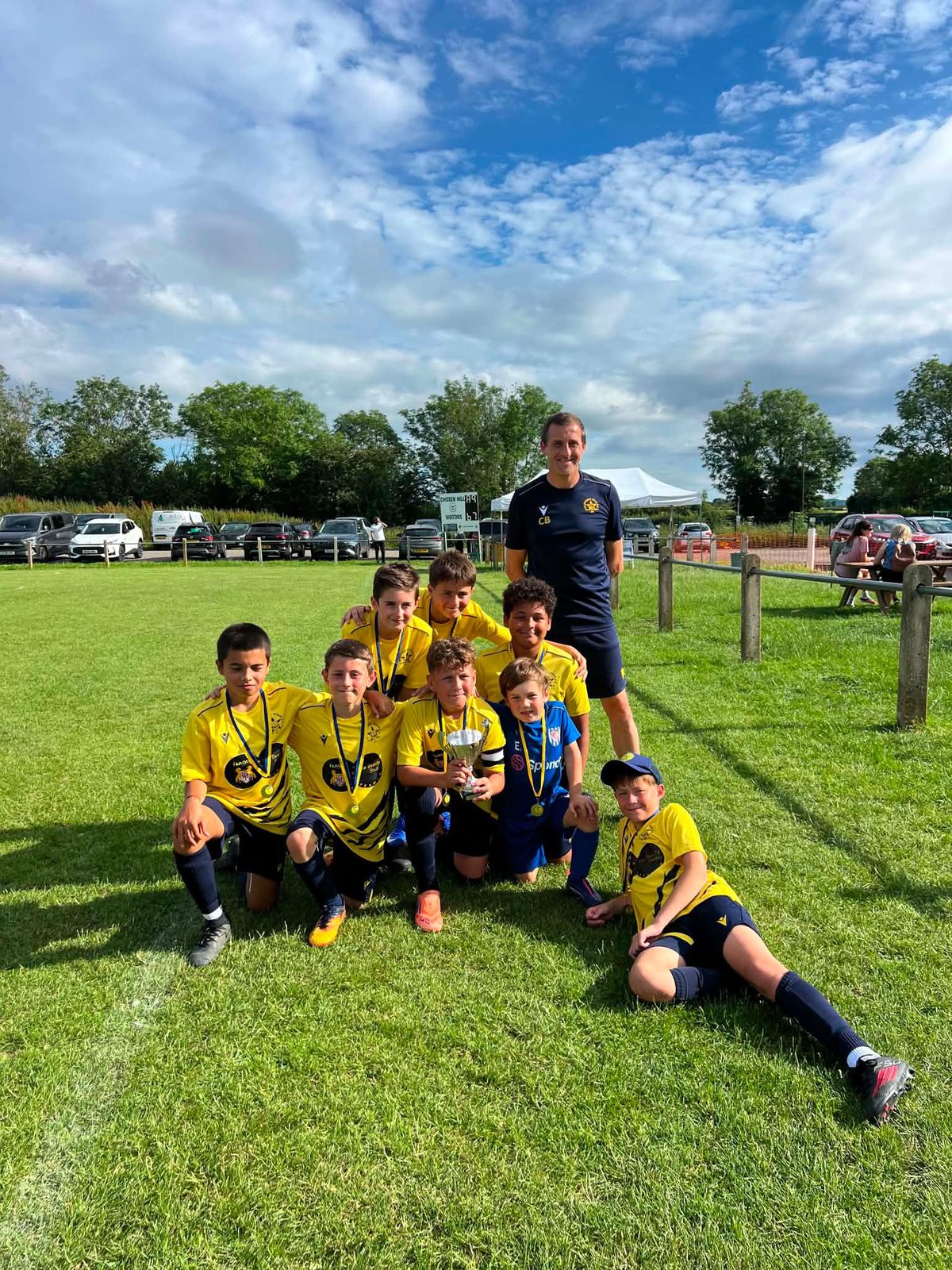 The Cheetahs on the grass with their trophy at the Hucclecote tournament