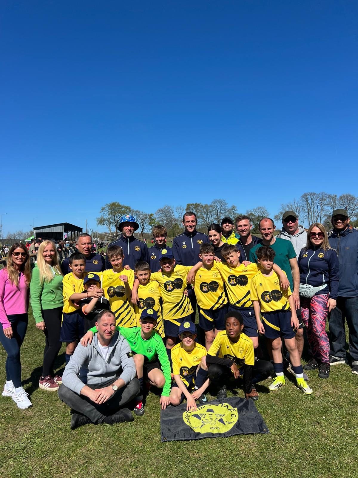 Cheetahs players, coaches and families together on the pitch at the Morlaix Football Cup