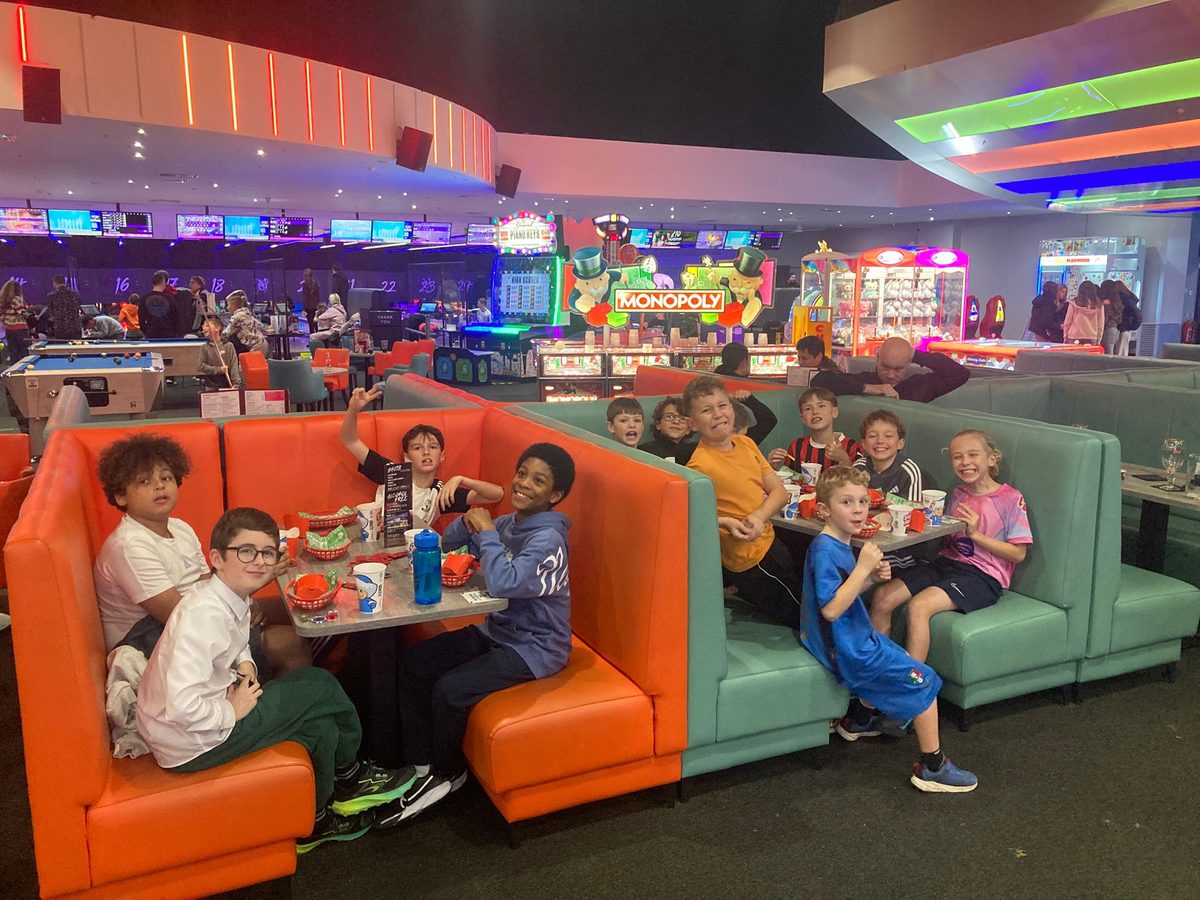 Cheetahs players sharing a booth at the tenpin bowling alley