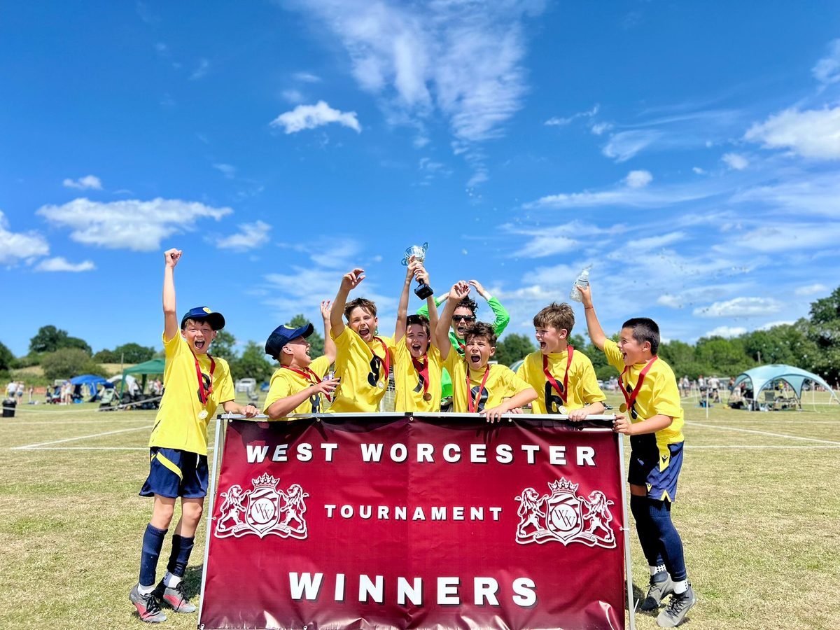 The Cheetahs celebrating behind the West Worcester Tournament winners banner