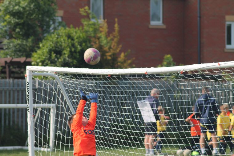 A young Southside Star goalkeeper tipping the ball over the crossbar
