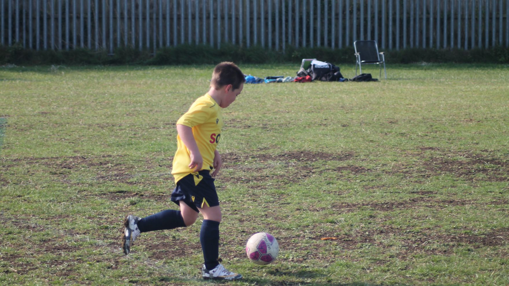 A Southside Star Youth FC player on the ball during a match in Cheltenham