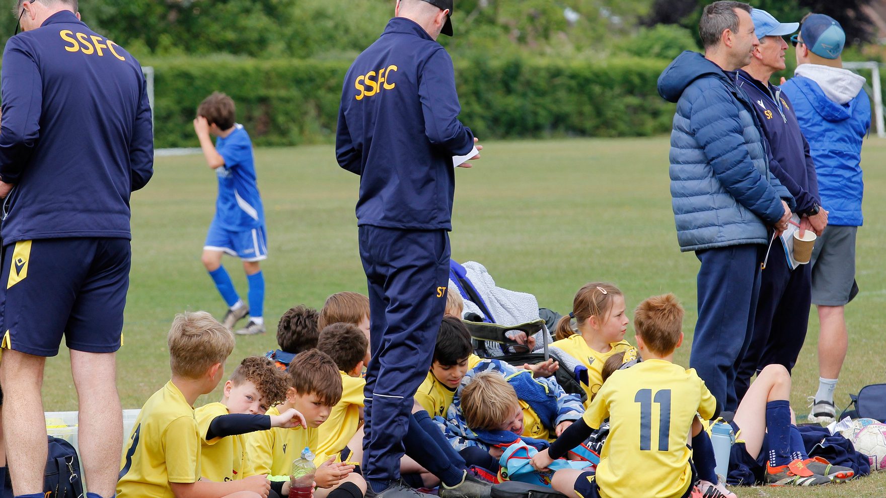 Southside Star coaches, players and parents gathered on the sideline during a match-day team talk