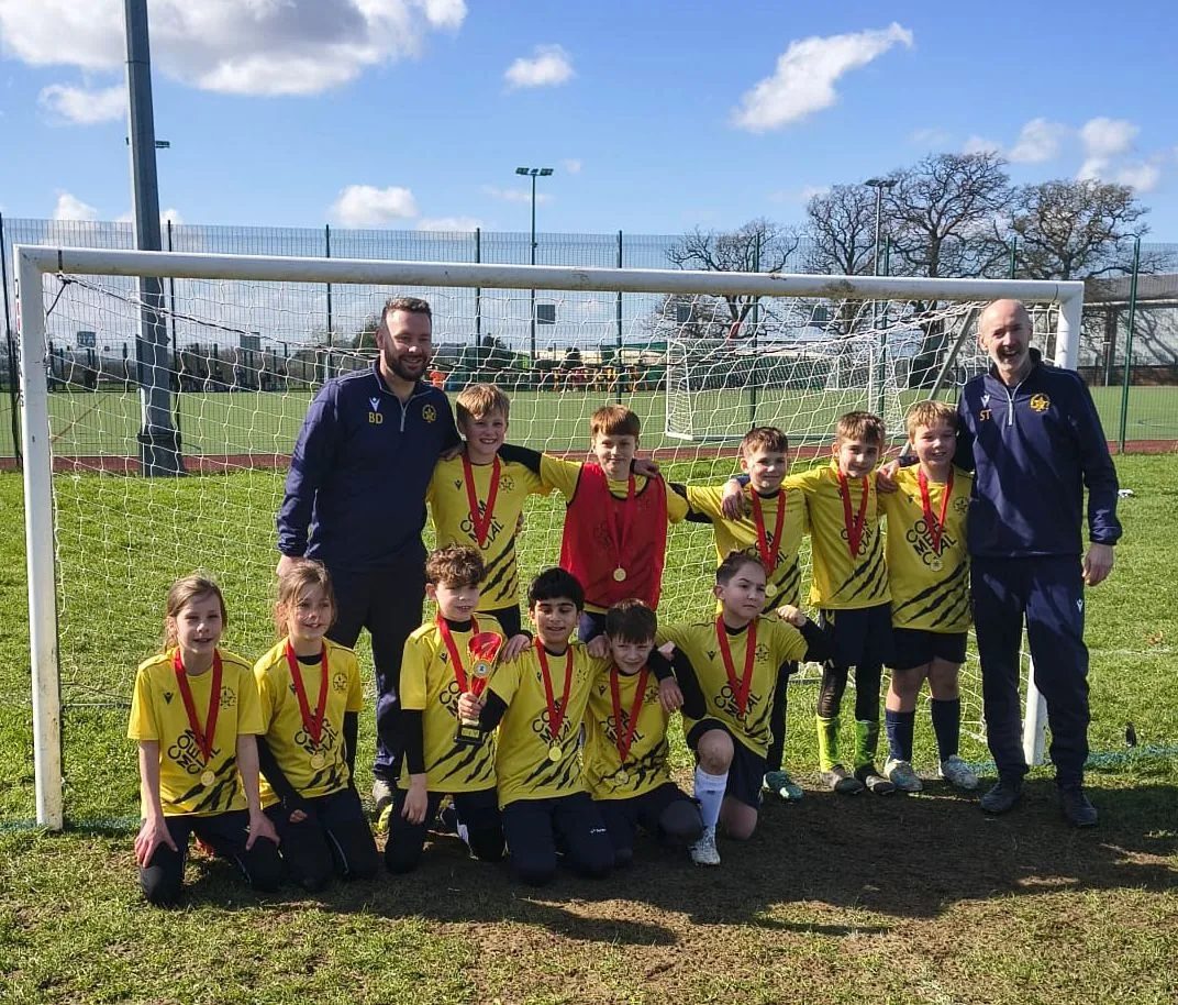 A mixed Southside Star team with their medals, flanked by their two coaches