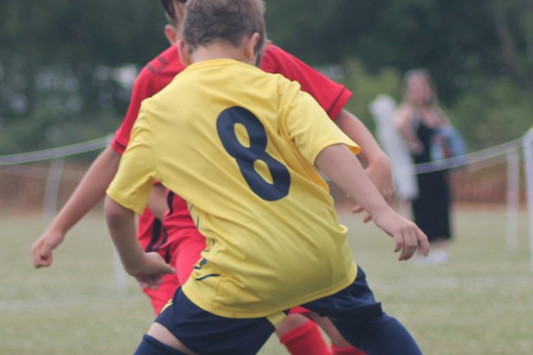 A Southside Star player driving forward with the ball at a summer tournament