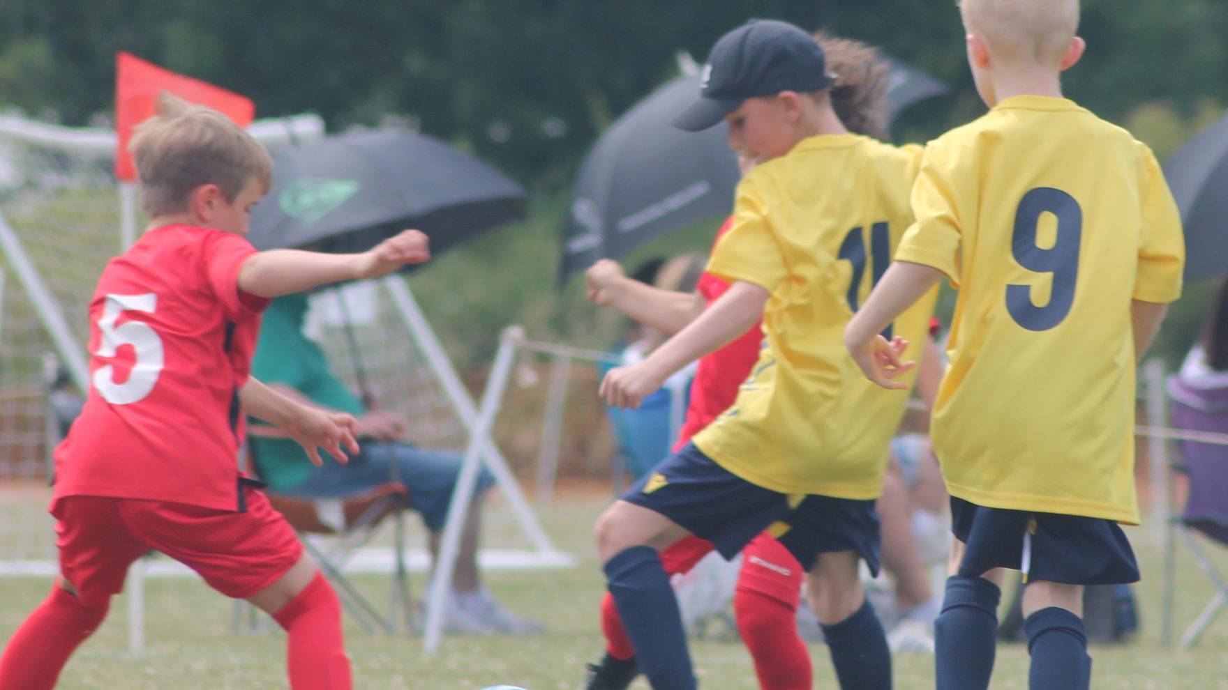 Southside Star Youth FC players competing on a bright match day in Cheltenham