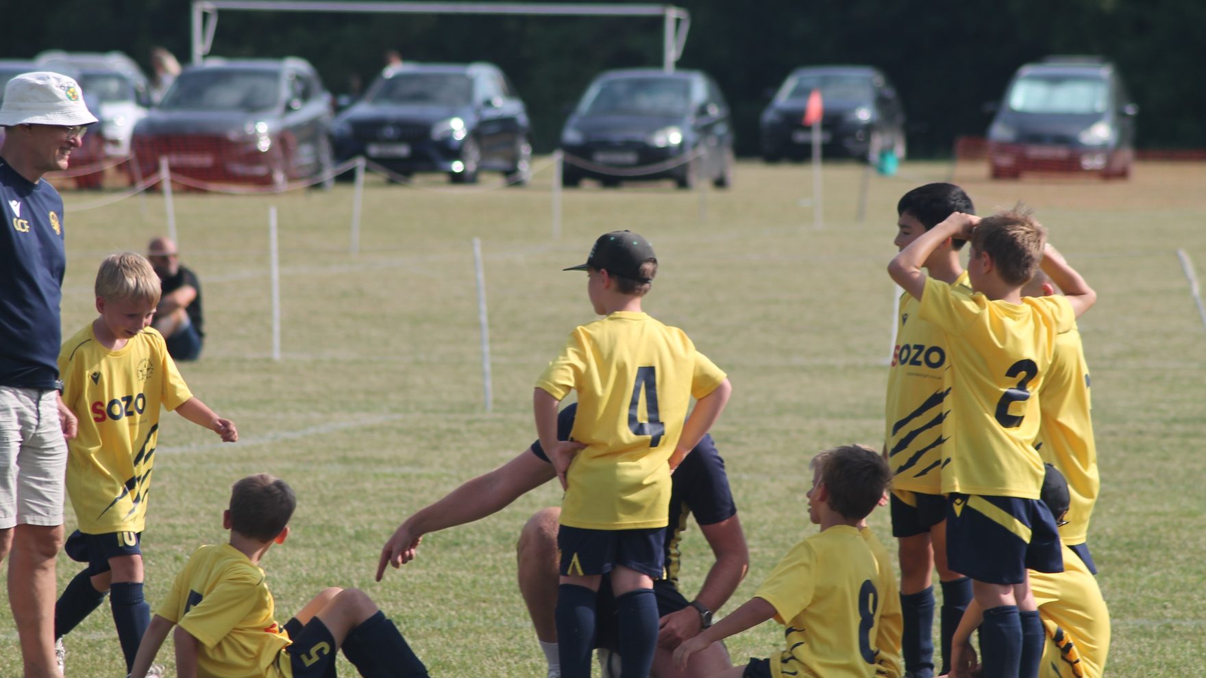 Southside Star Youth FC players in a team huddle on the pitch in Cheltenham